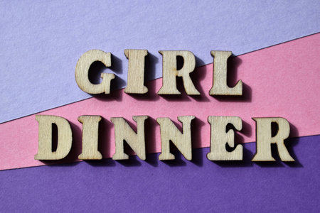 Girl dinner, words in wooden alphabet letters isolated on background. A meal typically consisting of snacks and side dishes of randomly selected foodsの写真素材