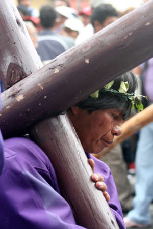 Quito, Ecuador, april 06, 2012 - penitent bearing a cross at the Good Friday processionのeditorial素材