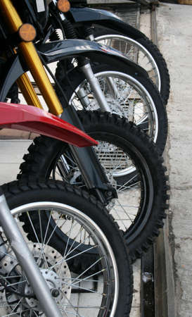 Wheels of four lined up motorbikes