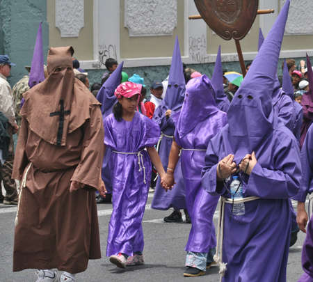 Quito, Ecuador - March 29, 2013: Penitents walking hand in hand  at the Good Friday procession のeditorial素材