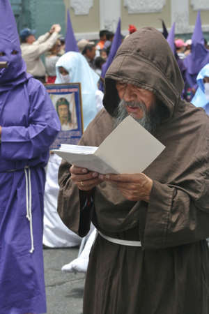 Quito, Ecuador - March 29, 2013: Reading monk at the Good Friday procession のeditorial素材