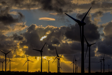 Wind turbines at sunset with cloudsの写真素材