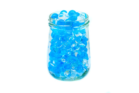 Polymer gel. Gel balls. balls of blue and transparent hydrogel, in glass bottle.の写真素材