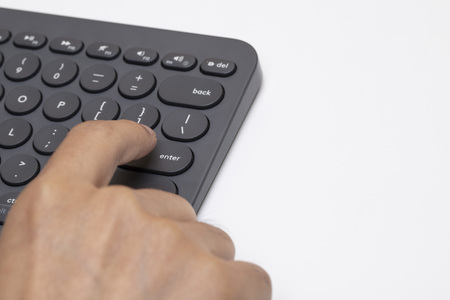 closeup right hand to press the enter button