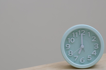 modern alarm clock stand on the table on white background for wake up in the morning