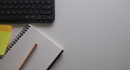 workplace with laptop computer and office supply on the white table in modern officeの写真素材
