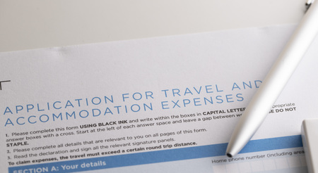 application for travel and accommodation expenses with pen on the tableの写真素材