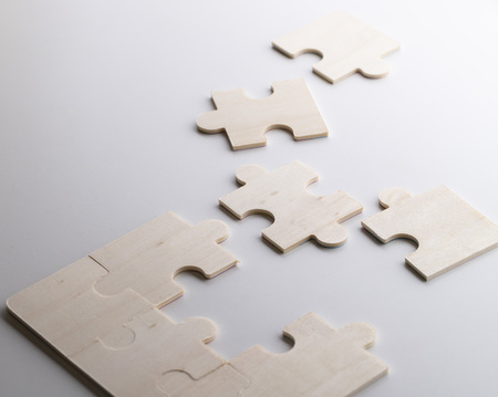 puzzles on a wooden background. Concept business. Idea: working in a team. Close up.の写真素材