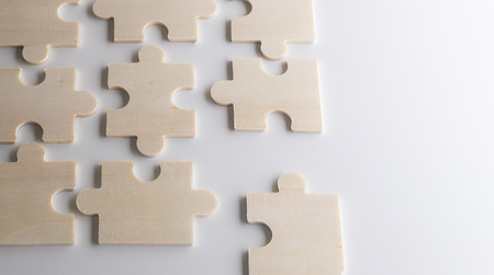 puzzles on a wooden background. Concept business. Idea: working in a team. Close up.の写真素材