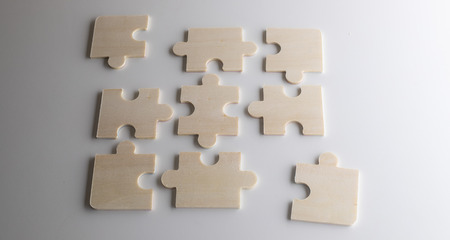 puzzles on a wooden background. Concept business. Idea: working in a team. Close up.の写真素材