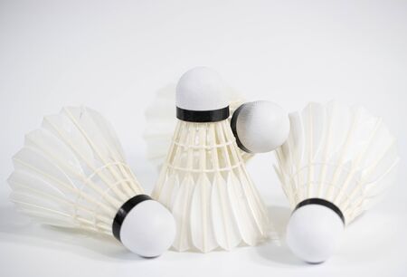 white badminton shuttlecocks lay on white table backgroundの写真素材