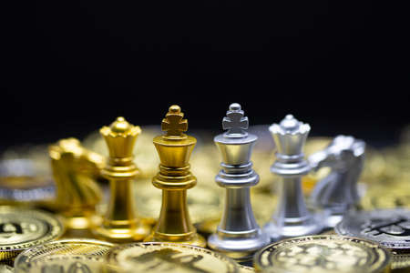 Gold and Silver King Chess on the Crypto currency is convenient payment in economy market, the modern way of exchange in the coming future for finance investment trade concept on the chess board background.の写真素材