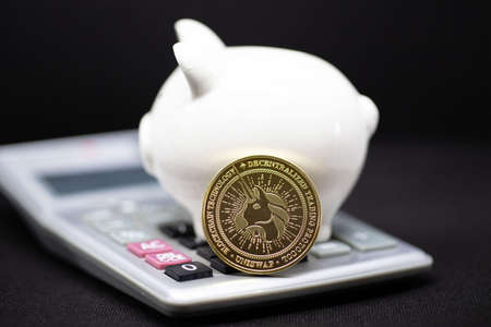 White piggy Bank on a black background and human hand putting coin in piggy bank for saving money wealth and finance concept and the copyspace for design.の写真素材
