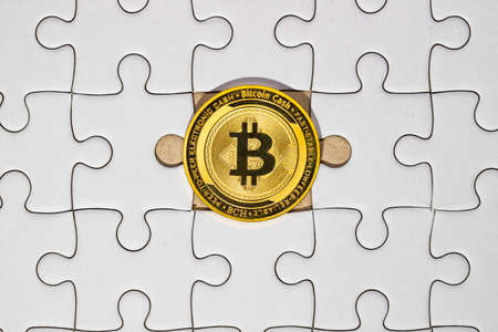 Gold bitcoin on the missing piece jigsaw. In the meaning way, business concept for the team in company is cooperate each other. Miss one in not complete but if have another one can replace he must have a valuable.の写真素材