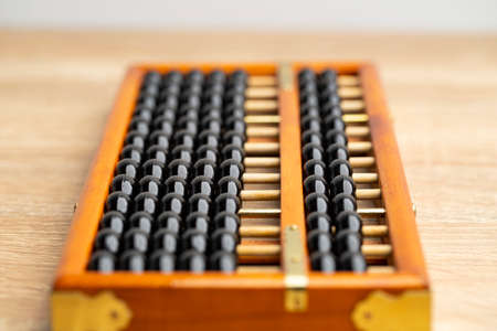 Chinese abacus vintage on the brown wood table front view and copy spaceの写真素材