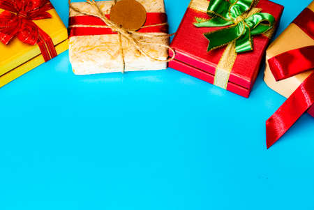 Gift boxes presents with ribbon on the cyan background. Top view with copy space.