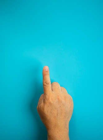 Hand with many actions meaning on the blue background, this action can let the message to another people to know what is it.の写真素材