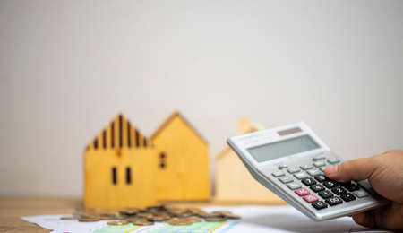 concept of money and finance to calculate income and expenses Pile of coins on graph paper on the...