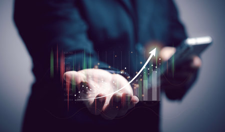 The concept of online stock trading. Businessman using stock chart to make stock buying decisions on mobile. stock market, business growth, progress or success concept. Invest in trading.の写真素材