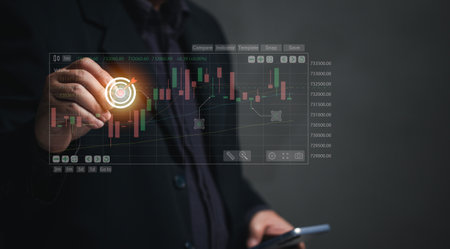 concept of stock trading. Businessman uses chart insights to make stock trading decisions by mobile phone, stock trading, futures trading. Derivatives Cryptocurrency.の写真素材