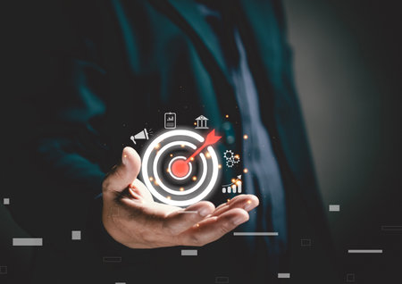 digital marketing goal. A businessman holds a virtual bullseye with a dart in the middle to target the positioning of his business. Using technology tools to connect to business network systems.の写真素材