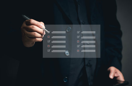 Questionnaire concept Online document management. DMS. Businessman checks list at virtual screen. Answering questionnaires about satisfaction Work via mobile phone or laptop. Satisfaction quality.の写真素材