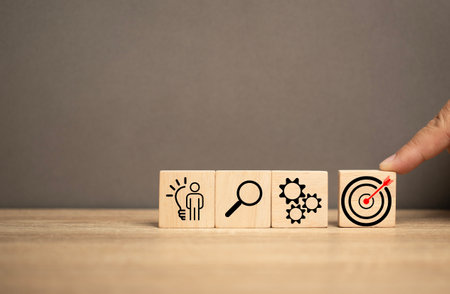 man push a wooden cube has the red dart in the middle. Business, Advertising, marketing and targeting. Clear and specific goals.Strategy plan for success target. Marketing plan idea strategy.の写真素材