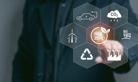 Man point at net zero icon and other on virtual screen. net zero emissions and Carbon neutrality concept. sustainable and clean tech. global warming. Environmental protection, climate eco energy.の写真素材