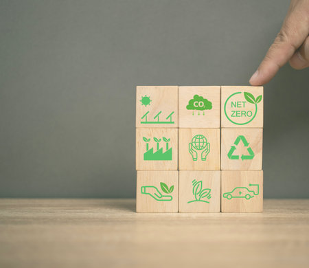 net zero emissions and Carbon neutrality concept. sustainable and clean tech. global warming. Environmental protection, climate eco energy. Man point on the net zero icon cube wood. Renewable power.の写真素材
