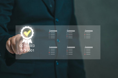 Businessman touches virtual screen on ISO9001 icon. Concept of doing qc pass and analyzing and collecting big data for business organizations. Making questionnaire Checking feedback. Quality control.の写真素材