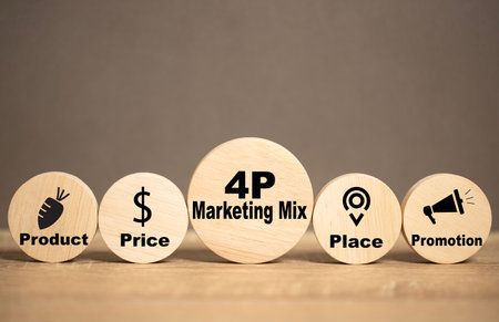 4P Marketing Mix icon on a round wooden plate placed on a table. Concepts about integrated marketing. Product, Price, Place and Promotion. Business strategy planning success achievement. Good teamwork.の写真素材