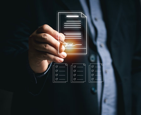 Businessman signs documents to approve work online using mobile virtual screen. Electronic signature and paperless office concept. E-signing. Technology and document management. Working online.の写真素材