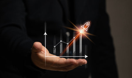 Man hand with stock market graph with rocket. Finance chart investment growth high. The currency trading economy strategy situation. Market and exchange analyzing data.の写真素材