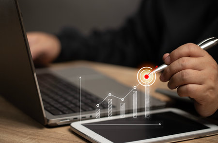 Businessman point the pen to the virtual screen for finance or stock chart graph. Stock and financial strategies marketing success investments goal planning.の写真素材