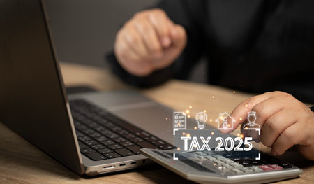 Businessman pressing calculator calculating annual tax payment. Financial investment budget online. Payment tax money online by mobile banking or laptop web application by internet.の写真素材