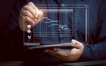 Businessman uses pointer pen on work schedule to make decisions at virtual screen. Planning of maintenance work. Managing work in various sections. Calendar management reminder event and appointment.の写真素材