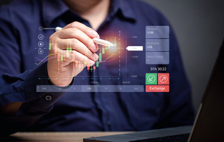 man use a pen to point out the intersection of bar graphs in deciding to buy stocks at a virtual screen. business growth. Finance and stock chart. Trade money and crypto currency exchange. Investment.の写真素材