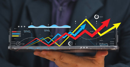 businessman a stock chart to determine buy and sell positions on the virtual screen of a tablet. information deciding buy stocks. Financial and stock chart investment growth.の写真素材