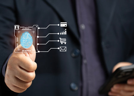 A man scans his fingerprint to verify his identity when making a business transaction on his smartphone, using a credit card online, shopping online, or encrypting the code to verify his email.の写真素材
