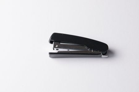 black stapler on a white background. Craft, paper, office concept.の写真素材