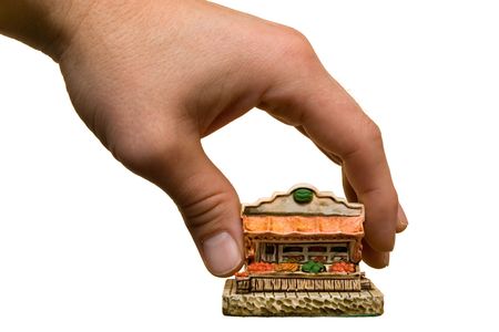 Hand holding small grocery store modelの写真素材