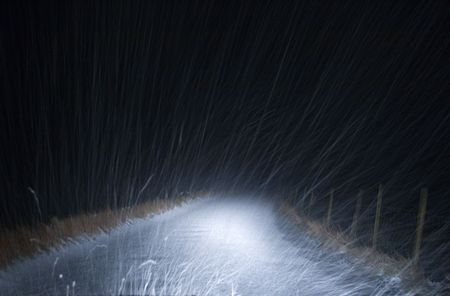 Hail, headlights and narrow rural roadの写真素材