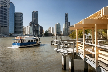 Ferry on river with Brisbane city behind, Australiaの写真素材