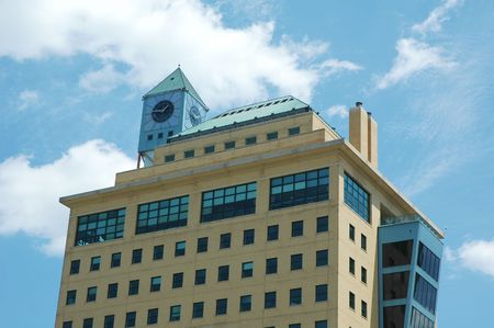 office building with blue sky and clock