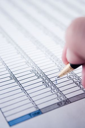 A calculator, pen, and financial statement.の写真素材