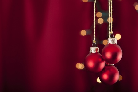 3 red baubles on a red and luminous backgroundの写真素材