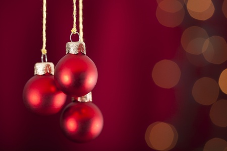 3 red baubles on a red and luminous backgroundの写真素材