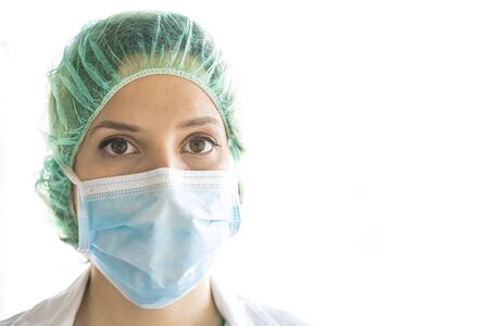 Young medical professional with procedure mask on her face