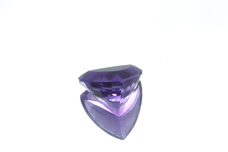 Purple amethyst on glass with reflection on neutral backgroundの写真素材