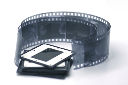 Composition with some slides of different colors and strips of 35 mm film in black and white on...